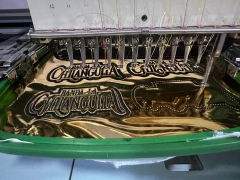Close-up of ornate typewriter keyboard showing decorative brass plating with Chanquihua branding and mechanical type arms