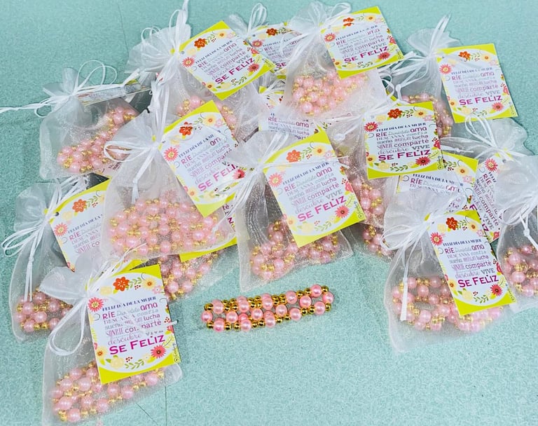 Multiple clear bags of pink and white popcorn with yellow labels arranged on a turquoise background
