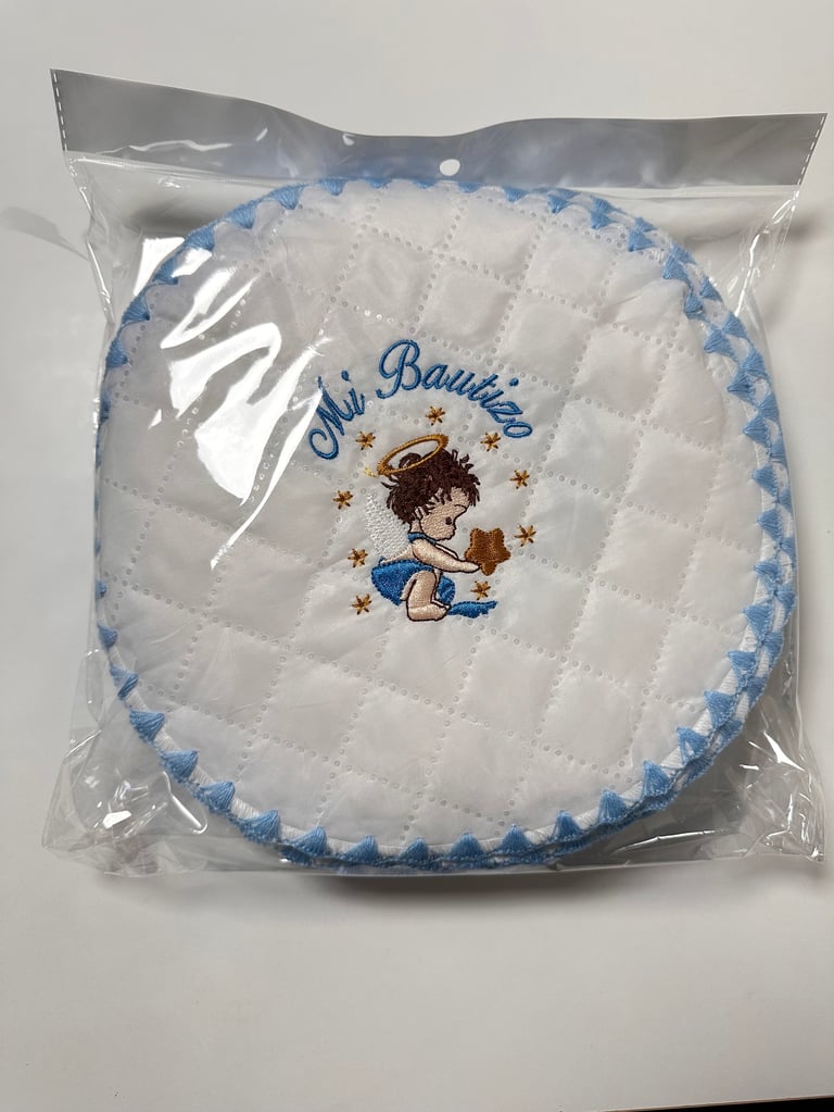 Packaged white quilted baby bib with blue scalloped trim and embroidered design featuring a cherub and stars with text Oh Bambino