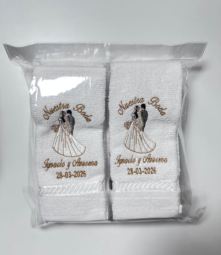 Package of two white embroidered towels with bride and groom design and wedding date 28-03-2026