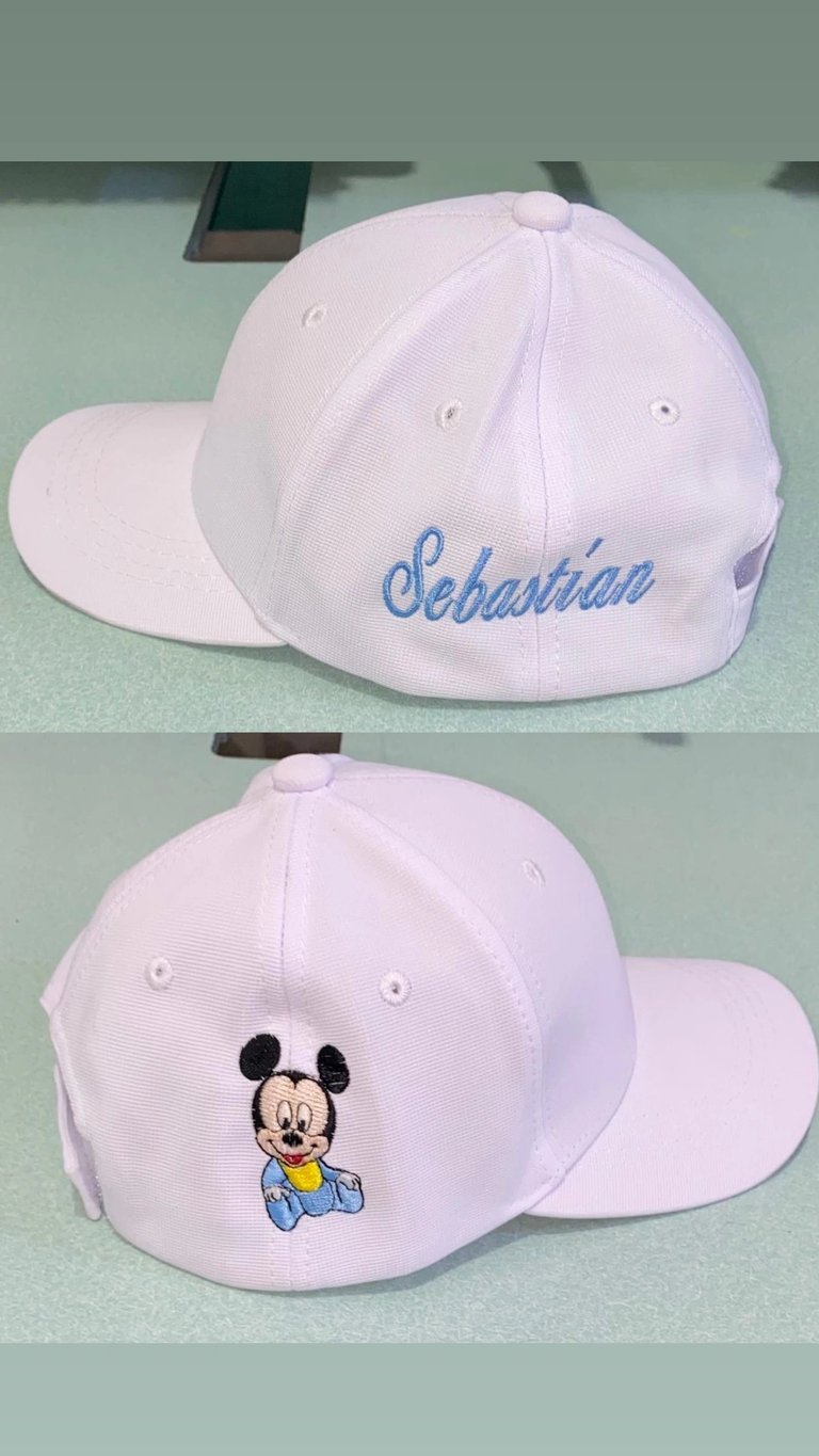 Light pink baseball cap with blue Sebastian embroidery on back and baby Mickey Mouse embroidery on front