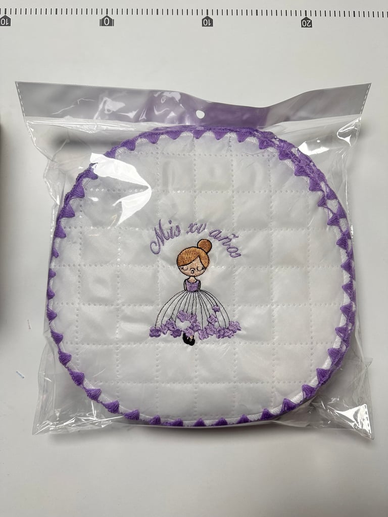 Packaged quilted coaster with purple scalloped trim and illustration of girl in purple dress with text this is me
